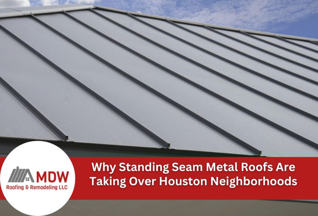 Gray standing seam metal roof with parallel ridged panels against blue sky