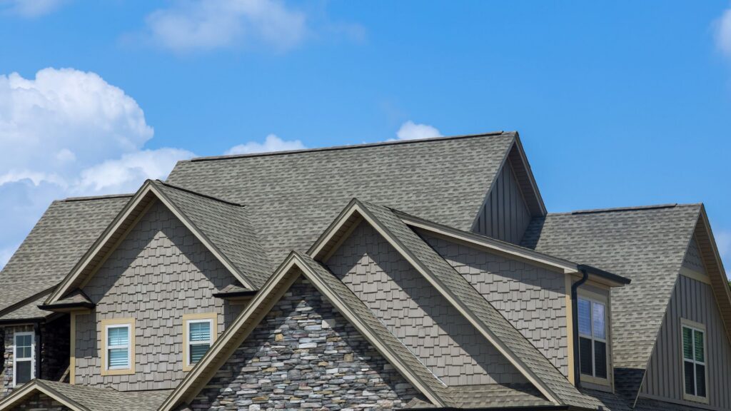 Charming house with multiple roofs under clear blue sky.