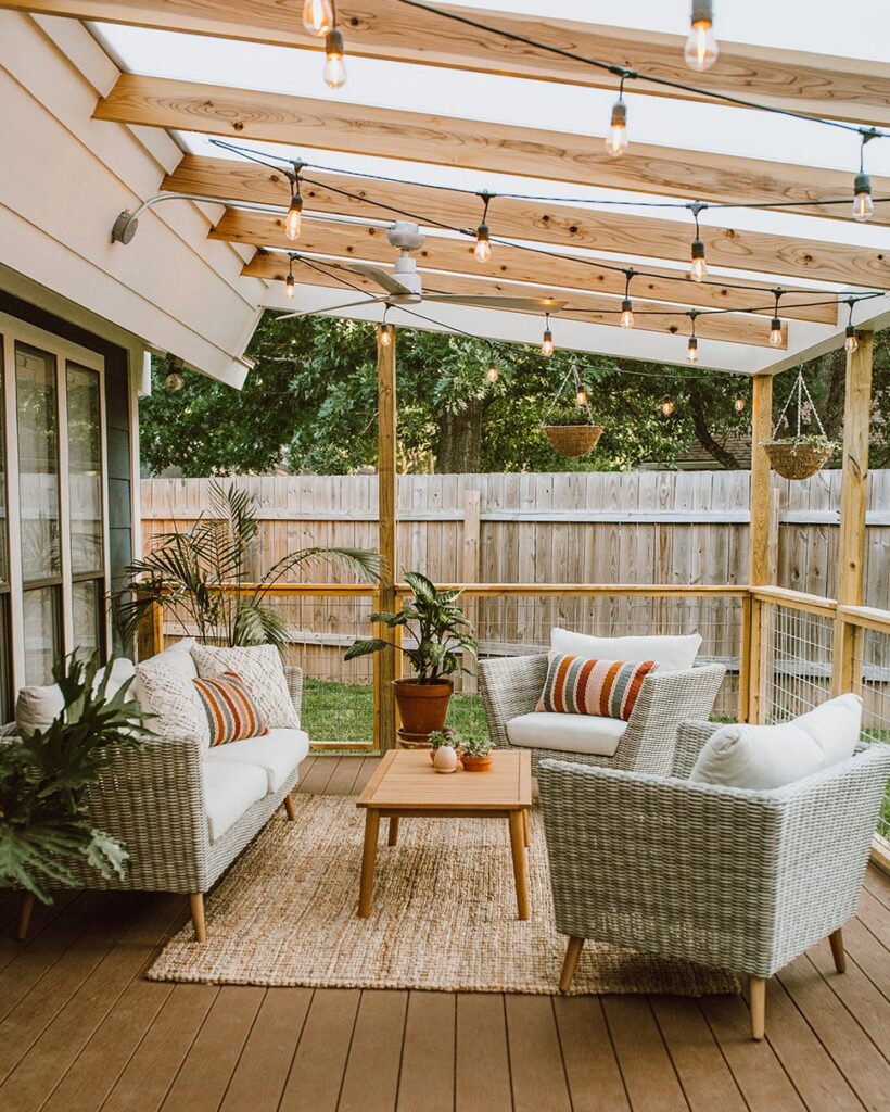 Cozy outdoor patio with wicker seating and string lights