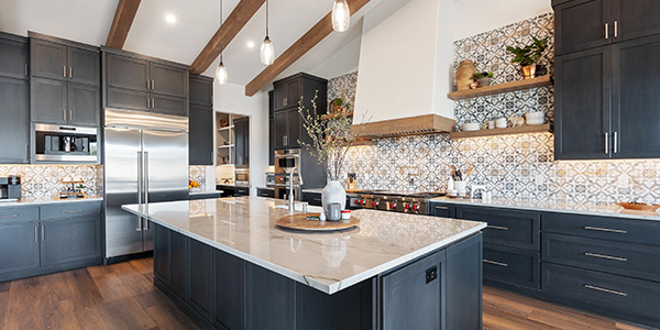 Modern kitchen with dark cabinets, island, and stylish lighting
